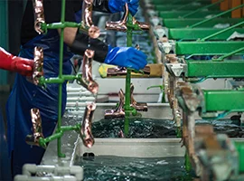 Workers electroplating metal faucet components