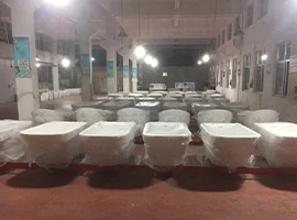 Wrapped bathtubs lined up in a well-lit factory room