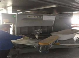 Worker operating machinery in a bathtub production area