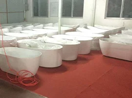 Finished bathtubs arranged in a factory storage area