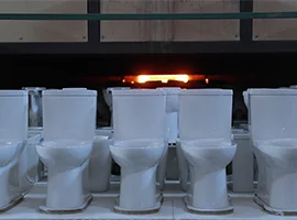 Toilets lined up for firing in a high-temperature kiln