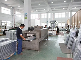 Workers operating machinery in the JaneDo sanitary ware factory