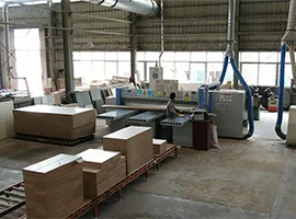 Worker operating machinery in bathroom cabinet production area
