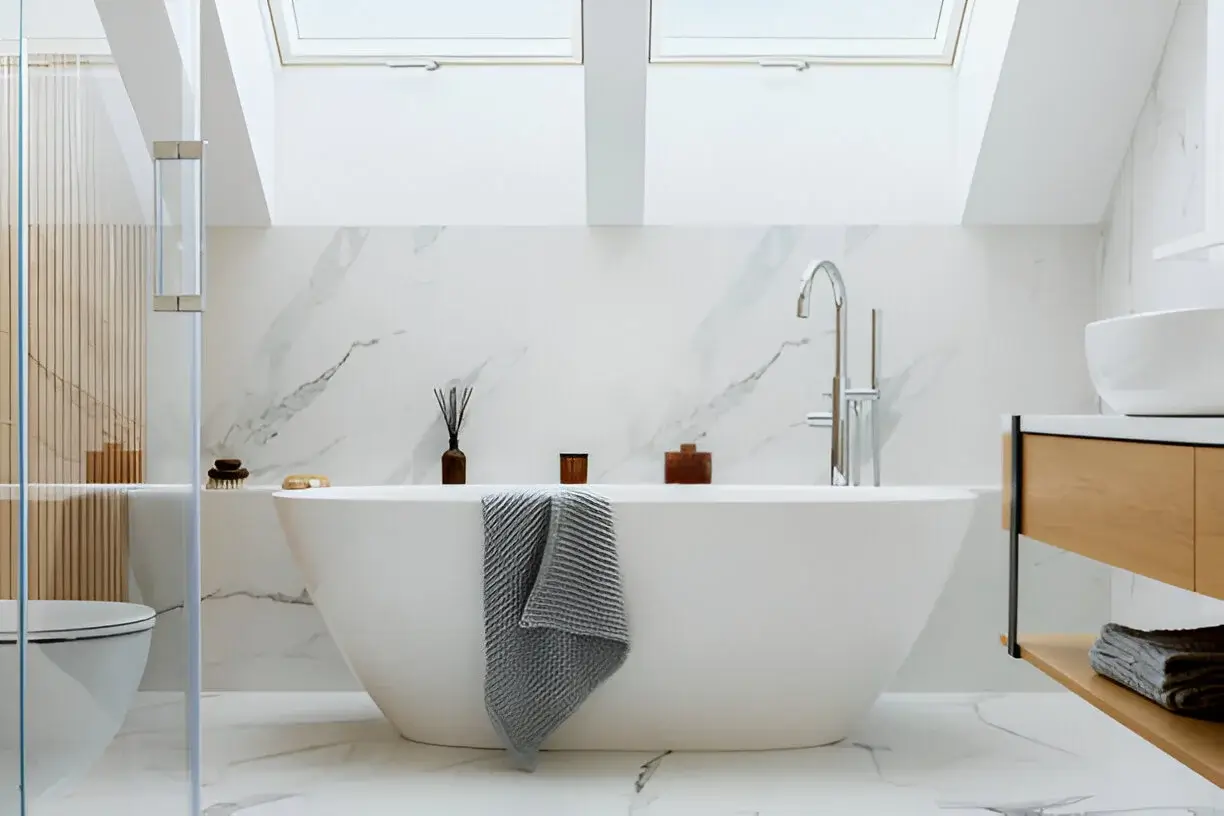 Elegant modern bathroom with freestanding tub under skylights